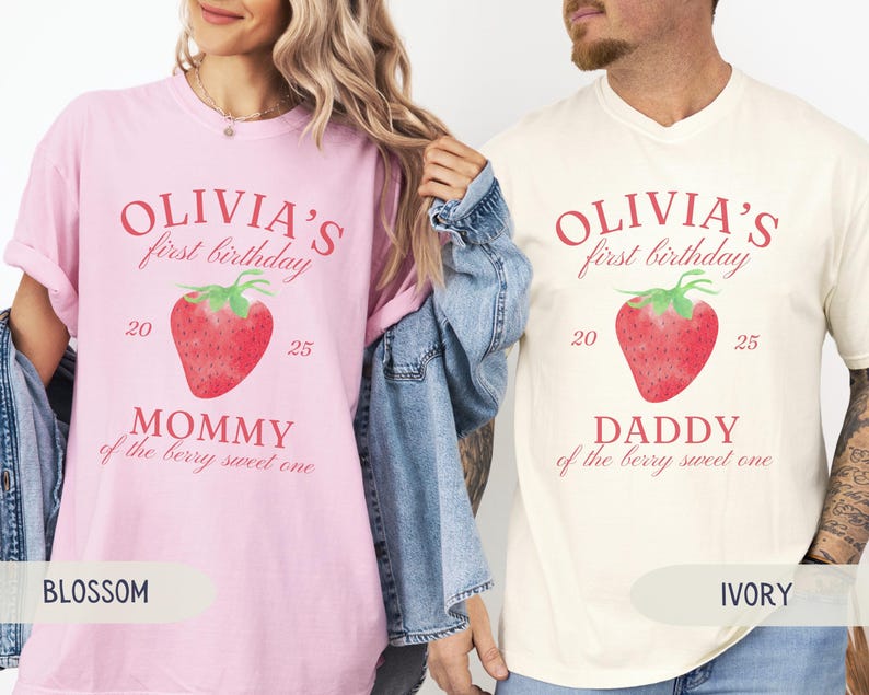 May include: Two t-shirts, one blossom pink and one ivory, feature the text "Olivia's first birthday" above a watercolor strawberry. The pink shirt says "Mommy of the berry sweet one," and the ivory shirt says "Daddy of the berry sweet one."