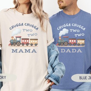 May include: Ivory and blue jean t-shirts with a train graphic. The ivory shirt says "Chugga Chugga Two Two Mama" and the blue jean shirt says "Chugga Chugga Two Two Dada". The train is blue, red, and yellow.