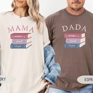Może przedstawiać: Kremowe i espresso koszulki z nadrukami "MAMA" i "DADA" nad stosami książek. Książki są w odcieniach czerwieni, fioletu i niebieskiego, z napisem "Sophia's first Chapter". Koszulki to odzież codzienna.