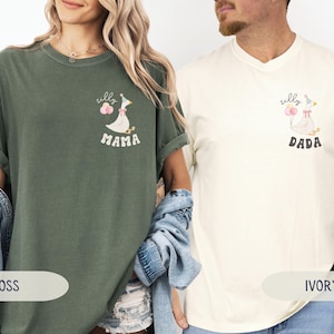 Pu&ograve; includere: Due t-shirt con un cartone animato di un'oca che indossa un cappello da festa e tiene dei palloncini. La maglietta verde dice "silly mama" e la maglietta avorio dice "silly dada".