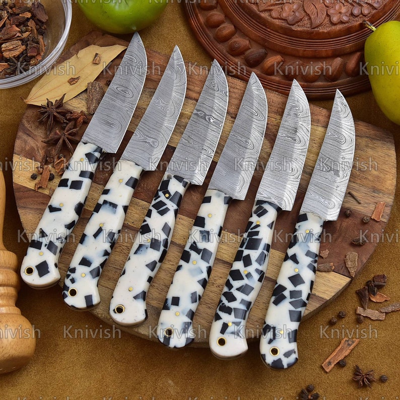 A steak knife is a sharp knife with a serrated blade that is used to cut steak. It has a long, thin blade and a pointed tip. The serrated blade helps to cut through the tough meat of steak. The long, thin blade allows the user to make precise cuts.