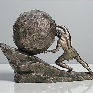 May include: A bronze-toned sculpture depicting the Greek myth of Sisyphus. The figure strains to push a large, textured boulder up a rocky incline. The sculpture is a detailed representation of the mythological figure.