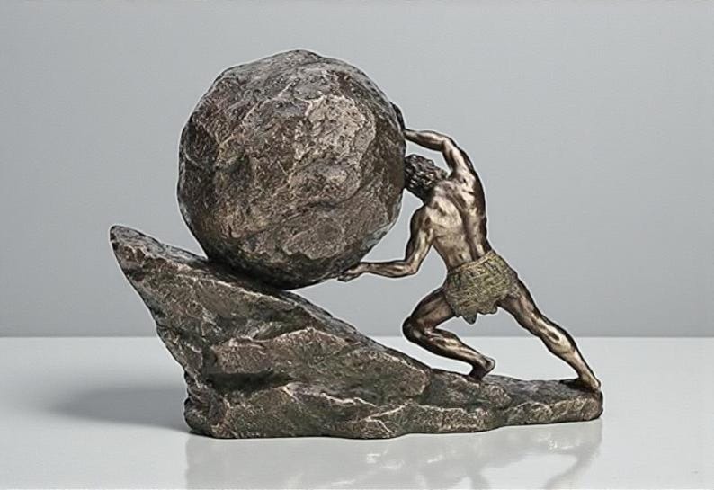 May include: A bronze-toned sculpture depicting the Greek myth of Sisyphus. The figure strains to push a large, textured boulder up a rocky incline. The sculpture is a detailed representation of the mythological figure.