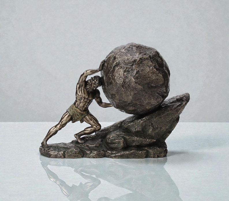 May include: A bronze sculpture depicting a muscular figure pushing a large, round stone uphill. The figure is wearing a loincloth and is positioned on a rocky base. The sculpture has a weathered, antique finish.
