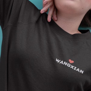 May include: Black sweatshirt with a white heart and the text "Wangxian" in white.