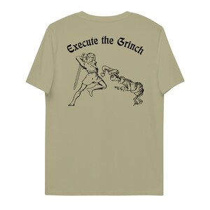 May include: A khaki t-shirt with a black illustration of a person holding a sword chasing a creature that looks like the Grinch. The text "Execute the Grinch" is printed above the illustration.