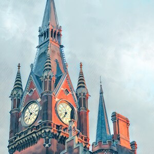 May include: A tall, red brick building with a pointed roof and two clock faces. The building has a gothic architectural style with intricate details and spires.