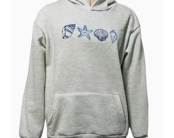 May include: A light gray hoodie with a front pocket and a drawstring hood. The hoodie features blue embroidered seashell designs across the chest. The cuffs and hem are a darker gray.