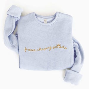 Forever Chasing Sunsets Graphic Sweatshirt (Light Blue color)