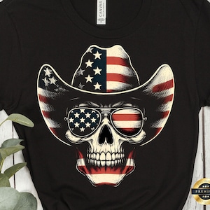 May include: A black t-shirt with a skull wearing a cowboy hat and sunglasses. The hat and sunglasses are decorated with the American flag.