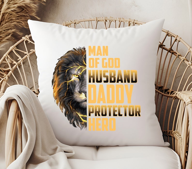 May include: White throw pillow with a black and gold lion graphic and the text "Man of God, Husband, Daddy, Protector, Hero".