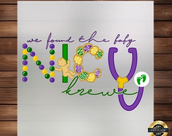 May include: A purple and green graphic design with the text "we found the baby krewe" and a baby in a purple and green wreath. The wreath is made of small purple and green beads and the baby is holding a purple and green stethoscope.