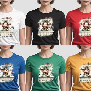 May include: A collection of t-shirts in white, black, red, blue, green, and yellow. Each shirt features a cartoon cow design with the text "Not to BRAG" and "but I can forget what I'm doing while I am doing it."