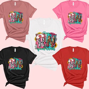 May include: Five different color t-shirts with a graphic design of the letters RN in a colorful, patterned design with the text "You RN good hands".