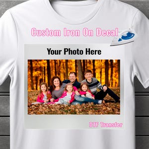 May include: White t-shirt with a custom iron-on decal featuring a family photo in an autumnal setting. The decal says "Your Photo Here" and "DTG Transfer".