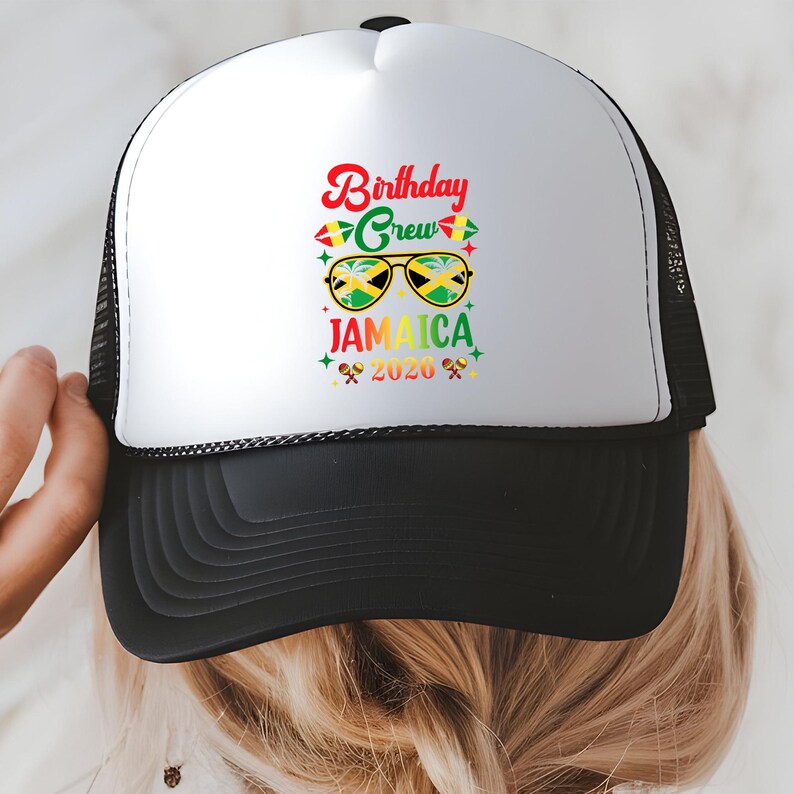 A person wearing a white and black baseball cap with a colorful graphic and text printed on it.