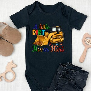 May include: Black baby onesie with a yellow bulldozer and the text "A little dirt never hurt".
