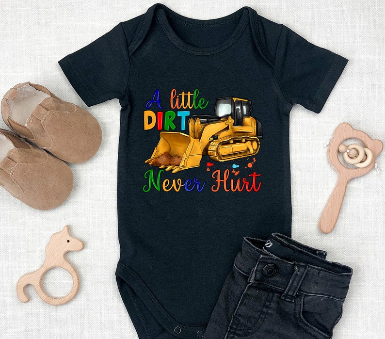 May include: Black baby onesie with a yellow bulldozer and the text "A little dirt never hurt".