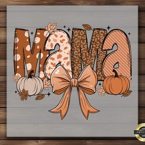 May include: A fall-themed graphic with the word "MAMA" in brown, orange, and tan patterns. A large peach bow is centered below the letters, with pumpkins and leaves on either side. The background is a gray wood grain.