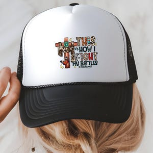 A person wearing a white and black baseball cap with a colorful graphic design on the front.