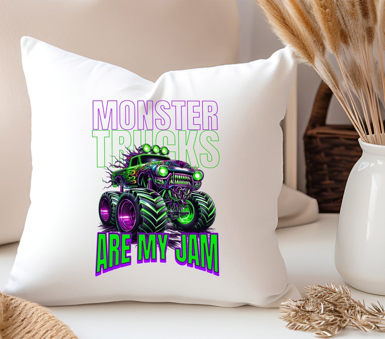 May include: White cushion with a green and purple monster truck graphic and the text "Monster Trucks Are My Jam".