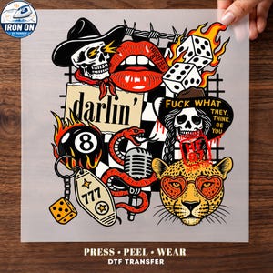 May include: A DTF iron-on transfer sheet featuring a collage of graphic illustrations including a skull in a cowboy hat, red lips, flaming dice, a billiard ball, a snake, a microphone, a leopard face with heart glasses, and the text darlin'.