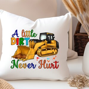 May include: White pillow with a yellow bulldozer graphic and the text "A little dirt never hurt" in rainbow colors.