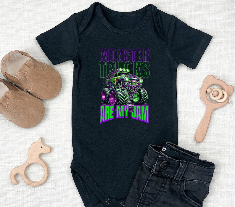 May include: Black baby grow with a green monster truck graphic and the text "Monster Trucks Are My Jam".