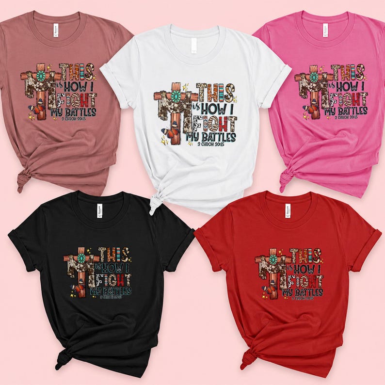 a collection of five t-shirts with the same design, featuring a cross and the text "This is how I fight my battles" printed on them.