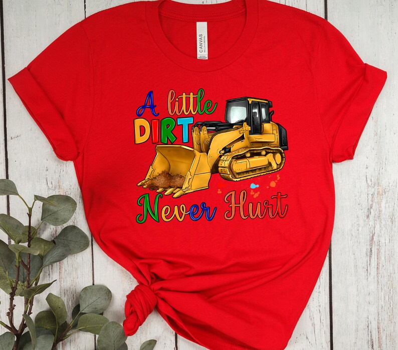 May include: Red t-shirt with a yellow construction vehicle and the text "A little dirt never hurt" in rainbow colors.