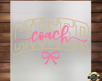 May include: Gold glitter cheer coach text with a pink bow on a white background.