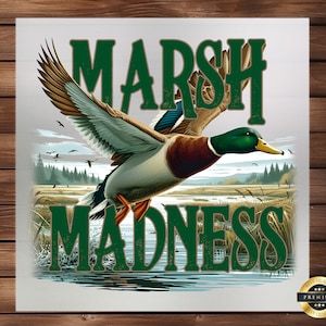 May include: A green and white graphic design with the text "Marsh Madness" and a mallard duck flying over a marsh. The design has a vintage look and feel.