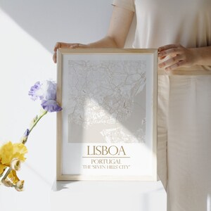May include: A framed map of Lisbon, Portugal, with the text "LISBOA" and "PORTUGAL THE SEVEN HILLS CITY" printed below the map.