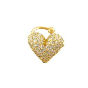 May include: A gold-colored ear cuff in the shape of a heart, encrusted with small, clear gemstones. The cuff has a curved design that wraps around the ear, with a small ball at the end.