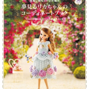 May include: A doll wearing a light blue crocheted dress adorned with pink and purple roses. The cover of a book is visible, with Japanese text and the English text "Coordinate dreaming Licca". The book cover has a floral background.