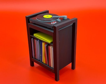May include: A black record player stand with a record player on top and a shelf below filled with colorful vinyl records.