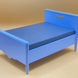 May include: A light blue wooden bed frame with a white headboard and a simple design. The headboard has the word "Shonk" written on it.