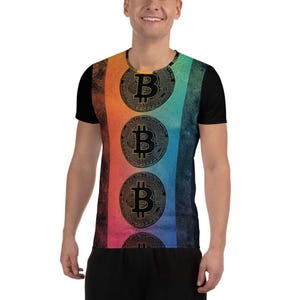 May include: A black t-shirt with a rainbow gradient background and a vertical row of four gold Bitcoin symbols.