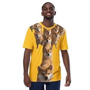 May include: A yellow t-shirt with a repeating pattern of Shiba Inu dogs. The dogs are arranged in a vertical line, with their heads facing forward. The shirt is a short-sleeved crew neck style.