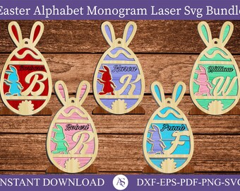 May include: Five laser cut wooden Easter egg ornaments with bunny silhouettes and a letter. The eggs are red, purple, green, pink, and blue. The letters are B, K, W, R, and F. The text "INSTANT DOWNLOAD" and "DXF-EPS-PDF-PNG-SVG" is at the bottom of the image.