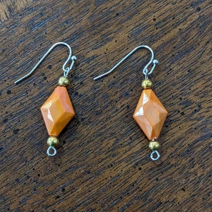 Diamond-shaped bead earrings in orange. 1&quot;