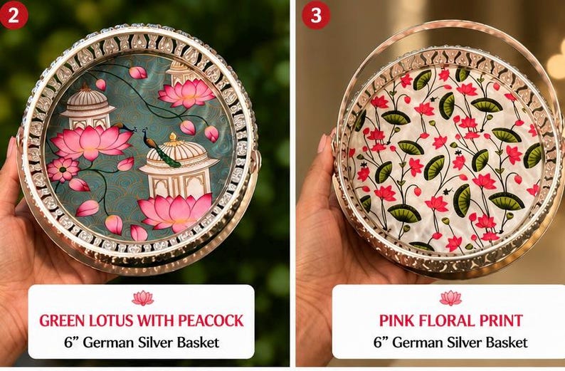 May include: Two round 6-inch German silver baskets with handles. The left basket features a green background with pink lotus flowers, white structures, and a peacock. The right basket has a white background with a pink and green floral pattern.