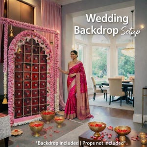 May include: A wedding backdrop setup featuring a large, rectangular, dark red wooden door frame adorned with pink and white floral garlands. The text Wedding Backdrop Setup is displayed in white. Gold bells hang from the top of the floral frame.