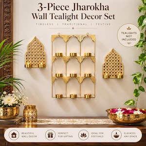 May include: A 3-piece Jharokha wall tealight decor set featuring gold-toned metal frames with intricate lattice patterns. The set includes one large rectangular wall-mounted candle holder and two smaller arched wall-mounted candle holders.