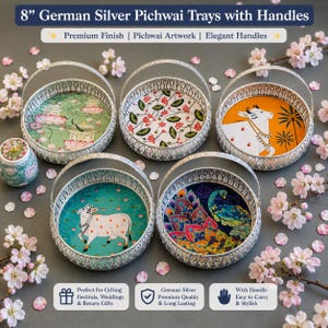 May include: Five round 8-inch German silver trays with arched handles, each featuring distinct colorful Pichwai-style illustrations including cows, peacocks, and lotus flowers, arranged with scattered pink cherry blossom petals.
