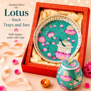 May include: A German Silver 8inch Lotus tray and jar set in a red gift box. The tray features a teal background with pink lotus flowers, a white pavilion, and a peacock. The matching jar has a lid with a clear knob and similar floral motifs.