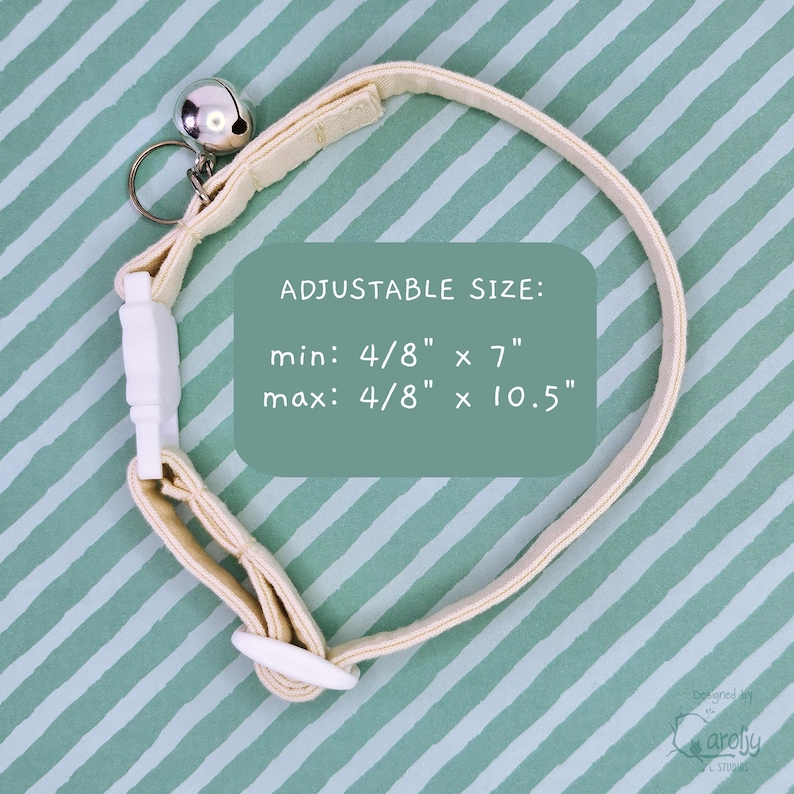 May include: A cream-colored pet collar with a silver-toned metal bell and a white plastic buckle. The text on the image reads: ADJUSTABLE SIZE: min: 4/8" x 7" max: 4/8" x 10.5". The collar features a sliding white plastic adjuster for sizing.