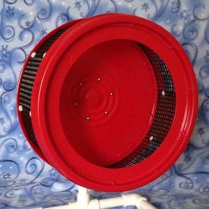 May include: Red hamster wheel with a white plastic stand. The wheel has a black wire mesh and white plastic accents.