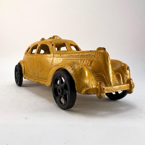 Antique Cast Iron Toy Taxi: Vintage Yellow Cab Collectible
