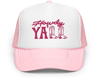 May include: A pink and white trucker hat with the words "Howdy Y'all" in a magenta script. The hat has a mesh back and a curved peak. The design includes two magenta cowboy boots.